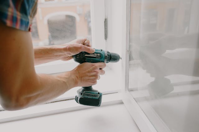 A man drilling wall