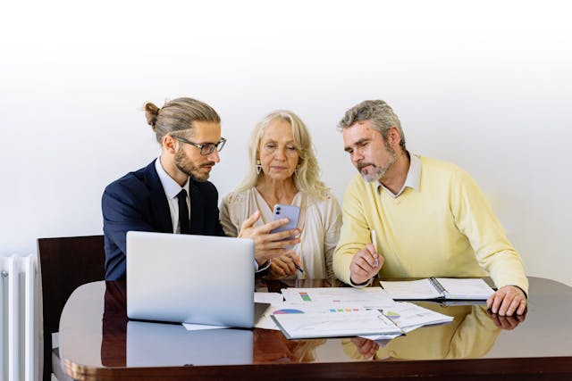 An agent talking to an elderly couple